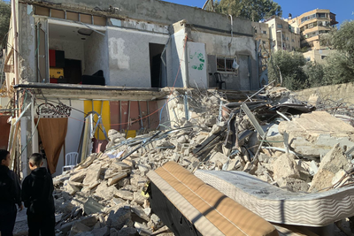 A Palestinian owner demolishes a two-storey residential building in Silwan, East Jerusalem, due to the absence of an Israeli-issued building permit. 